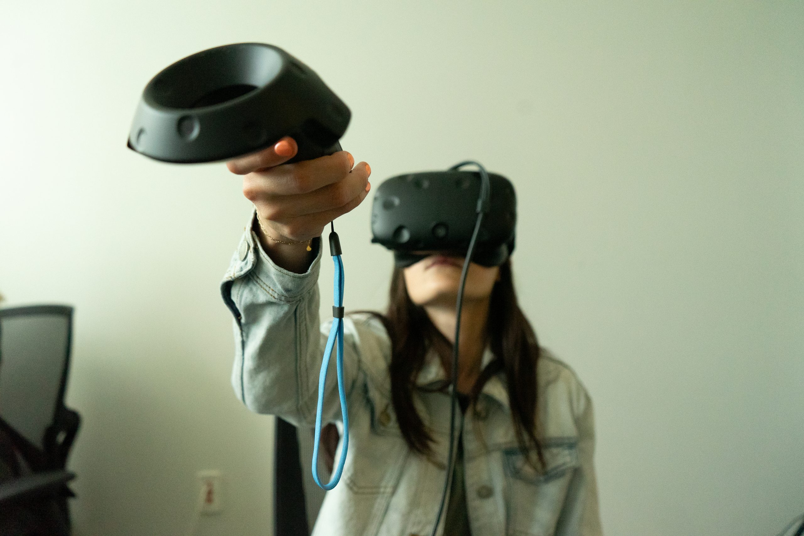 Woman wearing a VR headset and using a hand controller